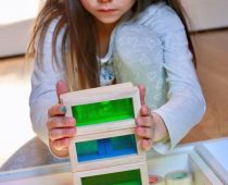 a girl with a box for sensory play